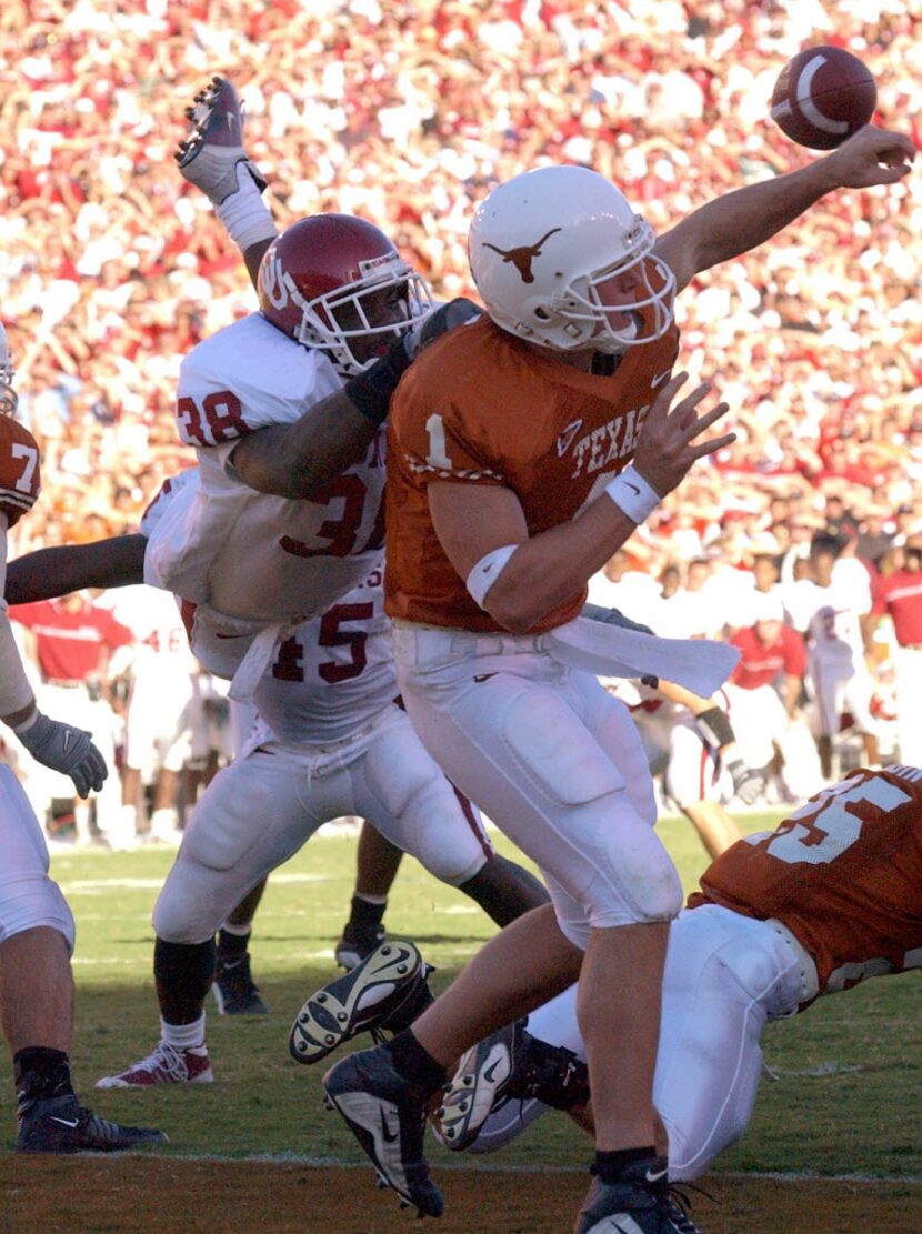 Texas quarterback Chris Simms (1) is hit by Oklahoma's Roy Williams (38) in the fourth...