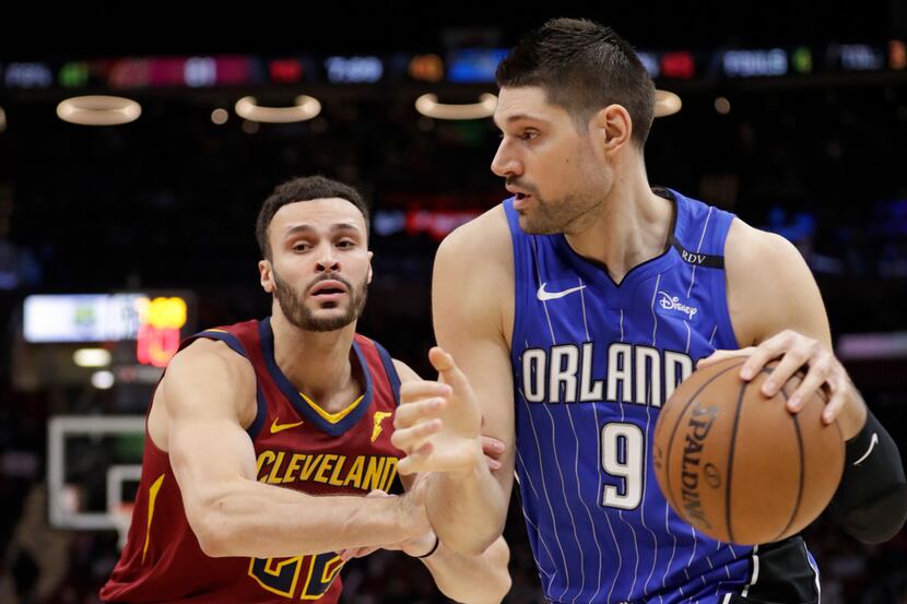Orlando Magic's Nikola Vucevic (9), from Montenegro, drives past Cleveland Cavaliers' Larry...