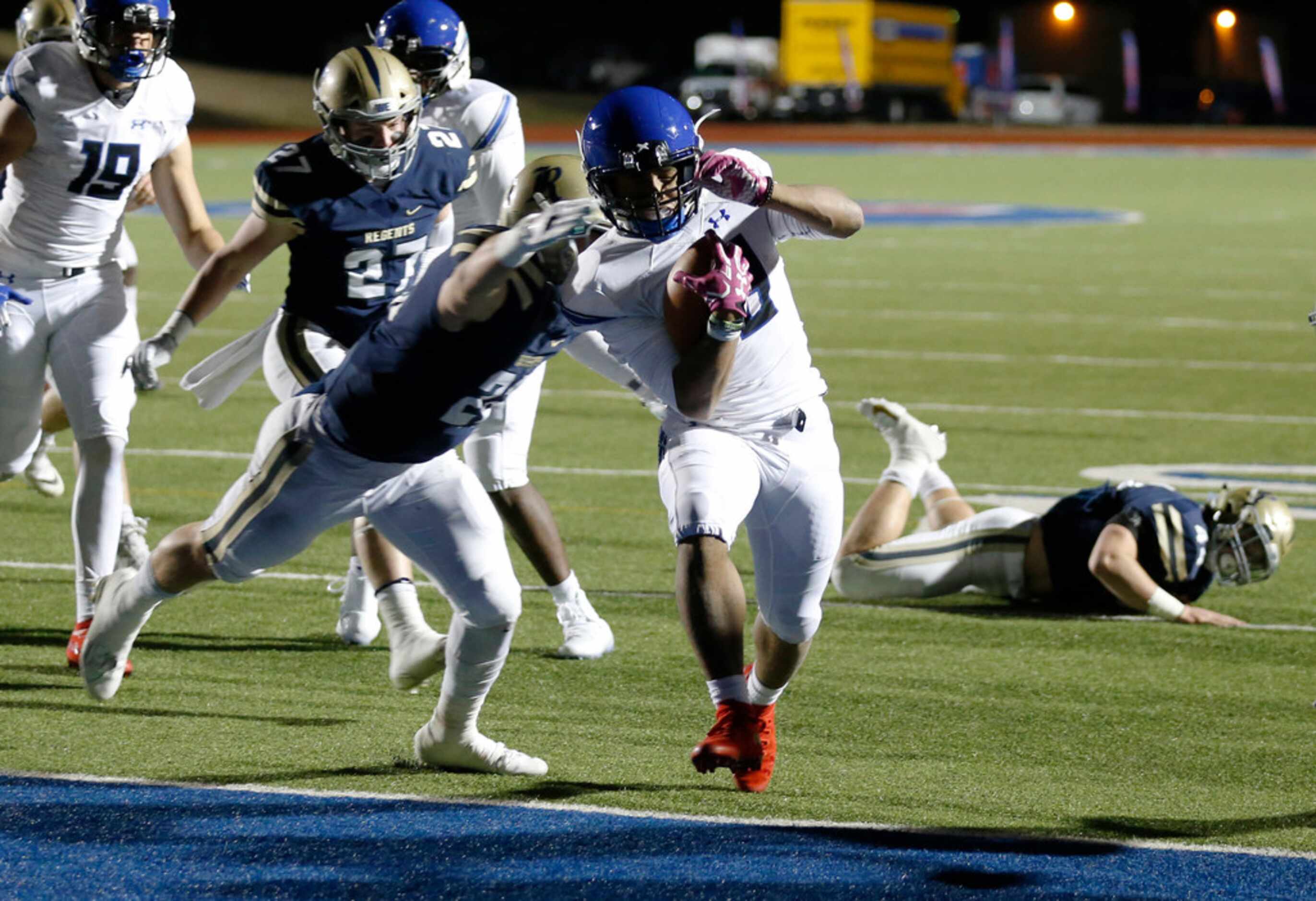 Trinity Christian's Emari Matthews (18) scores a touchdown as he is tackled by Austin...