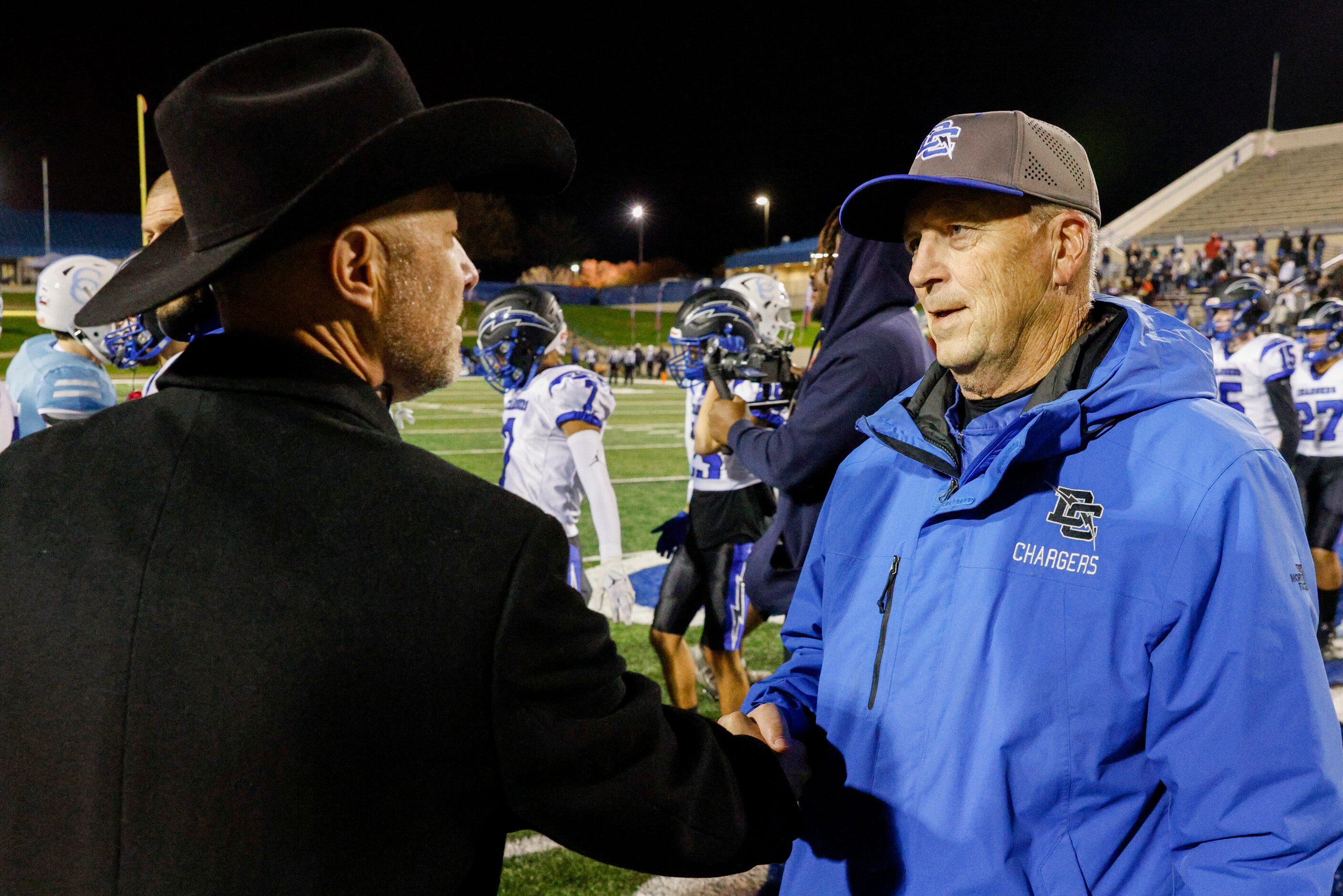 Dallas Christian head coach Mike Wheeler shakes hands with Houston Cypress Christian head...