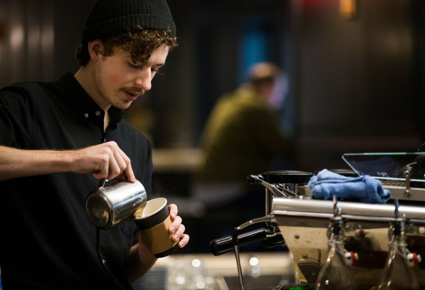 Barista Jeremy Taylor makes a coffee drink at Otto's coffee shop.