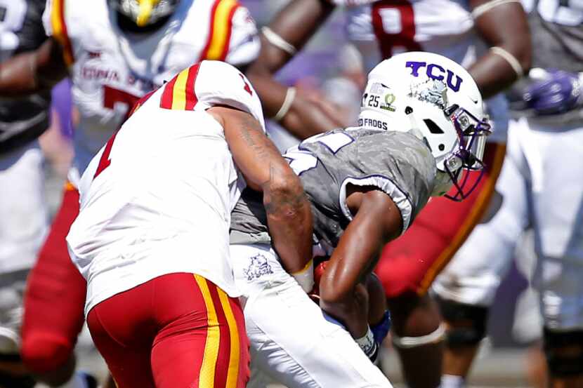 TCU wide receiver KaVontae Turpin (right) is tackled by Iowa State defensive back D'Andre...