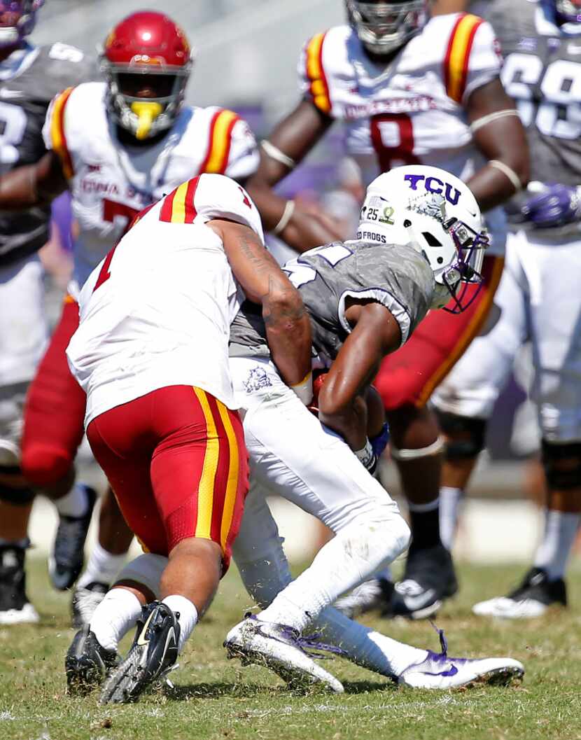 TCU wide receiver KaVontae Turpin (right) is tackled by Iowa State defensive back D'Andre...