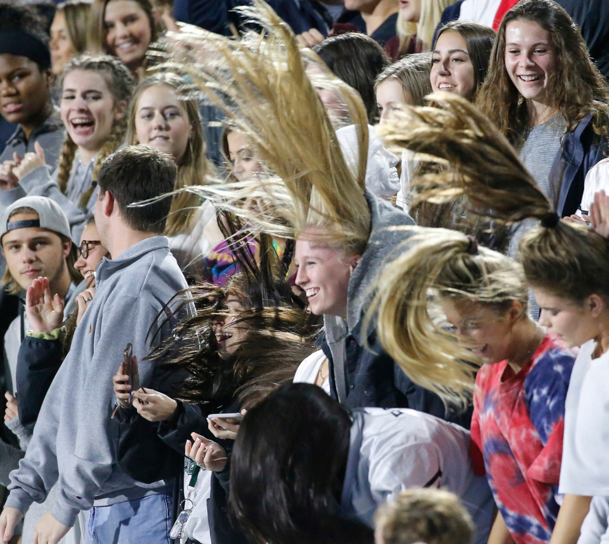 Prosper fans sling their hair as the drumline stirs up the crowd in the second half during...