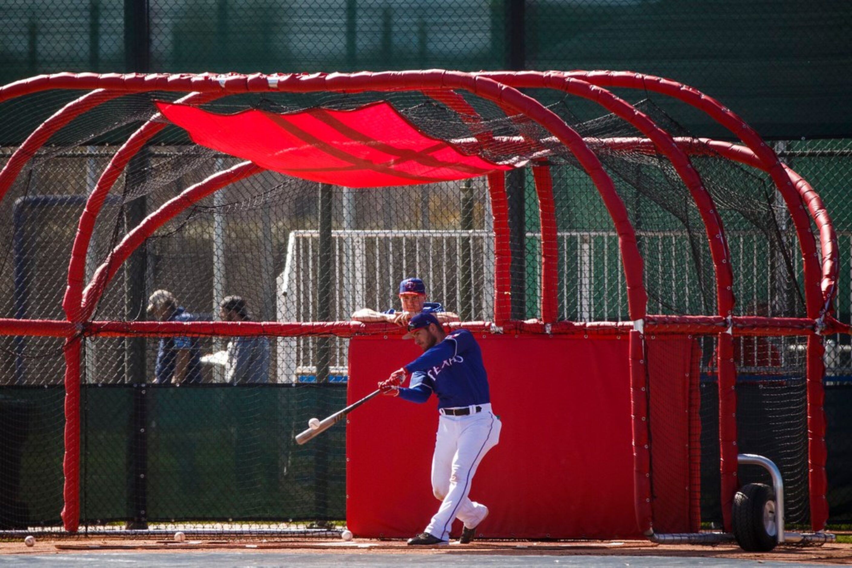 Texas Rangers catcher Jeff Mathis takes batting practice during a spring training workout at...