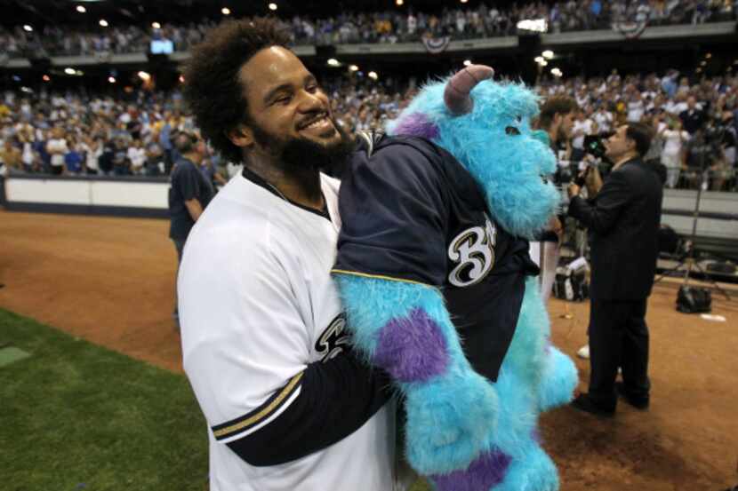Prince Fielder #28 of the Milwaukee Brewers celebrates with a stuffed animal after the...