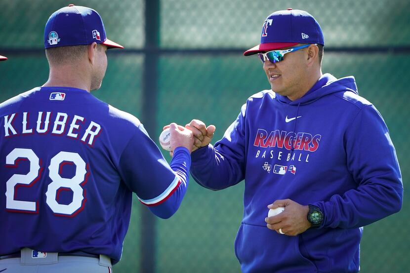 Texas Rangers pitcher Corey Kluber fist bumps with pitching coach Julio Rangel after...
