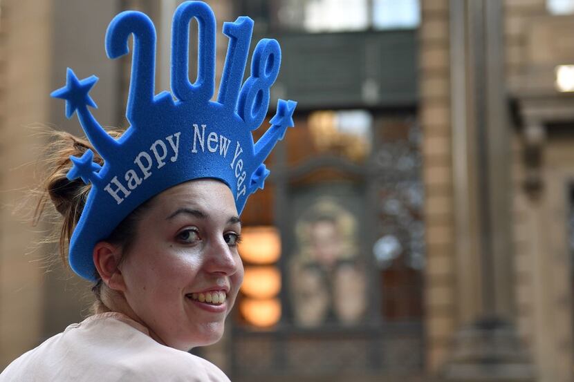 A woman sells "Happy New Year 2018" headgear at Martin Place in Sydney on Dec. 30.