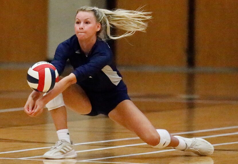 Flower Mound High School outside hitter Gabby Walker (9) receives a serve during game three...