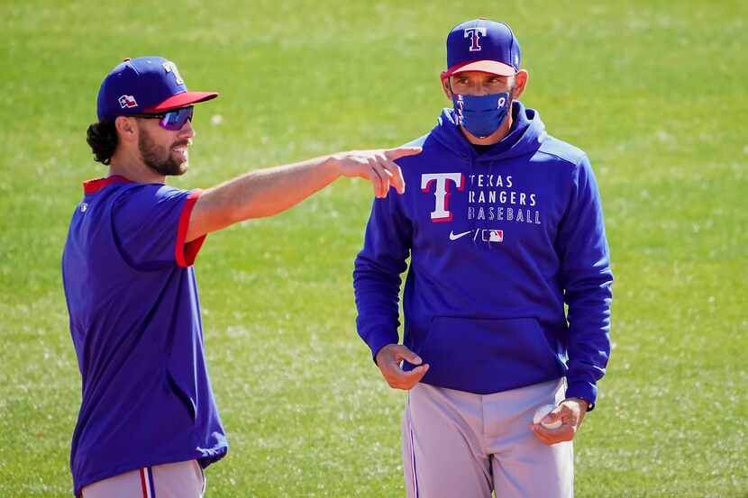 Texas Rangers infielder Charlie Culberson (left) talks with manager Chris Woodward during a...