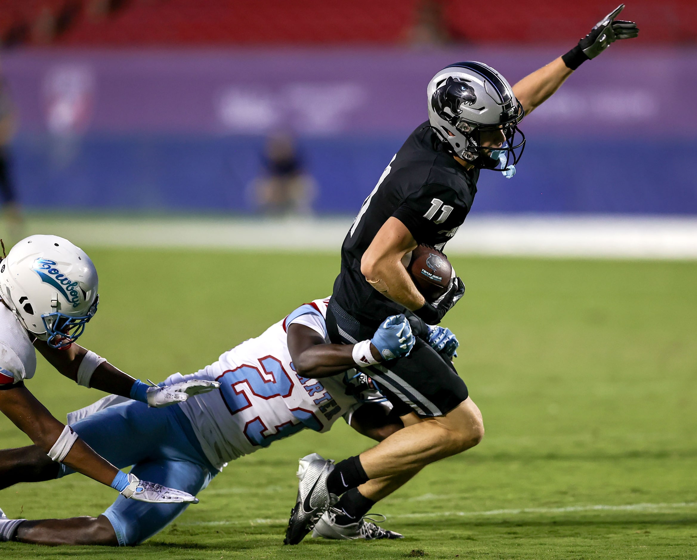 Frisco Panther Creek wide receiver Cristian Trickett (11) tries to break away from Dallas...