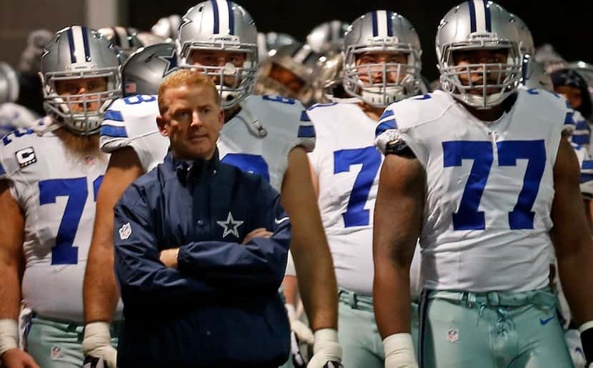 Dallas Cowboys head coach Jason Garrett and his players wait to take the field against New...