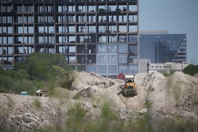 
As bulldozers work at Toyota’s North American headquarters site, foreground, developer...