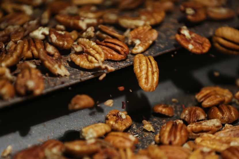 Inspectors look for insect bites, discolorations and remaining shell while examining pecans...