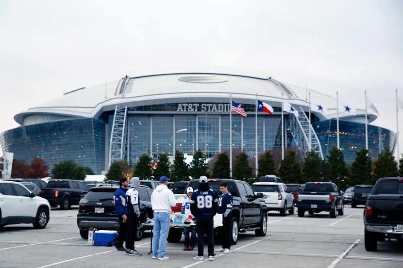 Dallas Cowboys fans tailgate outside AT&T Stadium in Arlington, December 4, 2022. The...