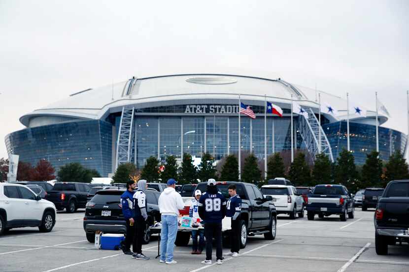 Dallas Cowboys fans tailgate outside AT&T Stadium in Arlington, December 4, 2022. The...