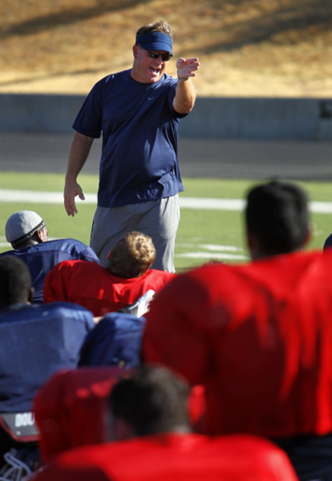 Denton Ryan head coach Joey Florence delivers a post practice speech to his players.