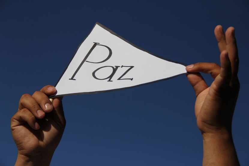 A man held a sign reading "peace" during the march for peace and against violence in Ciudad...
