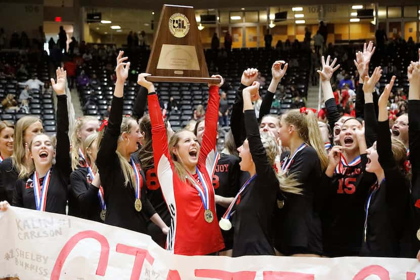 Lovejoy High School libero Ava Camacho (7) holds the state championship trophy after her...