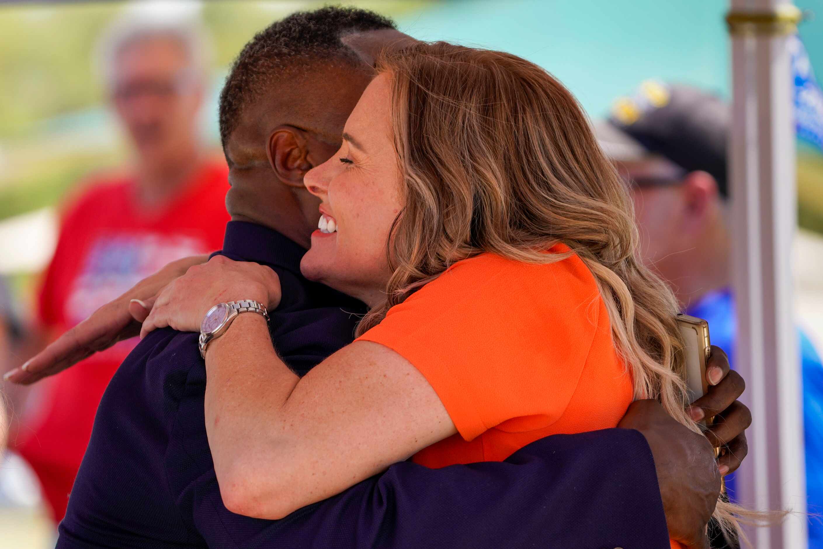 Shelley Luther, owner of Salon  la Mode,  hugs Keenan Williams, Strategic Initiatives...