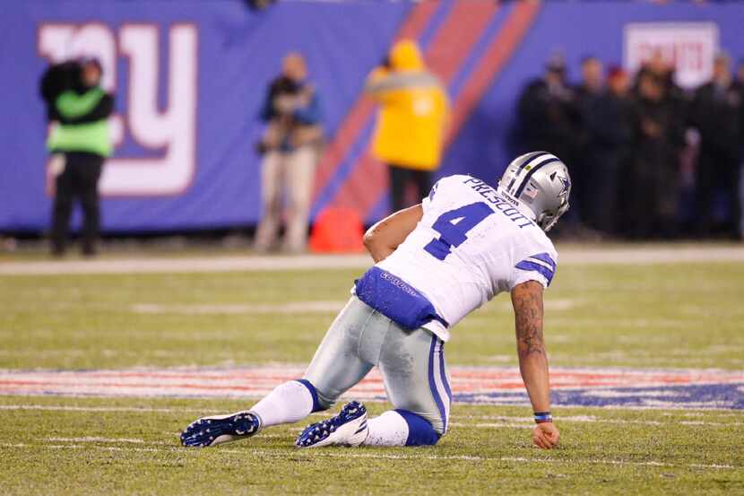 Dallas Cowboys quarterback Dak Prescott (4) sits on the turf after fumbling the ball away in...