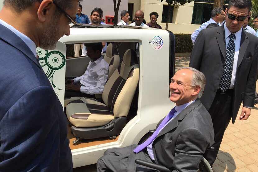 Texas Gov. Greg Abbott examines, before actually hauling himself into and driving, an...