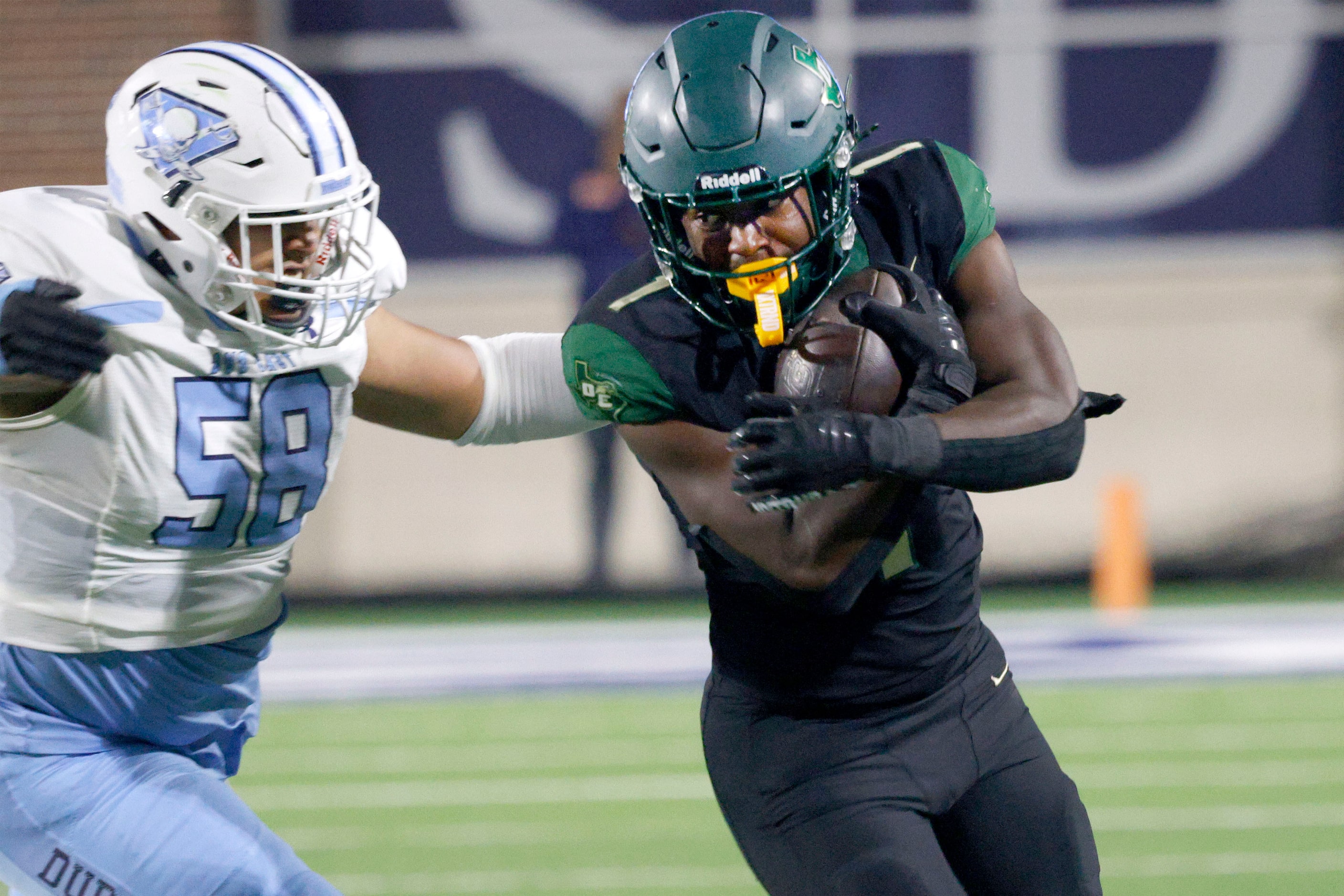 DeSoto's Deondrae Riden Jr. (1) keeps the ball away from Wylie East's Daniel Marquez (58) in...