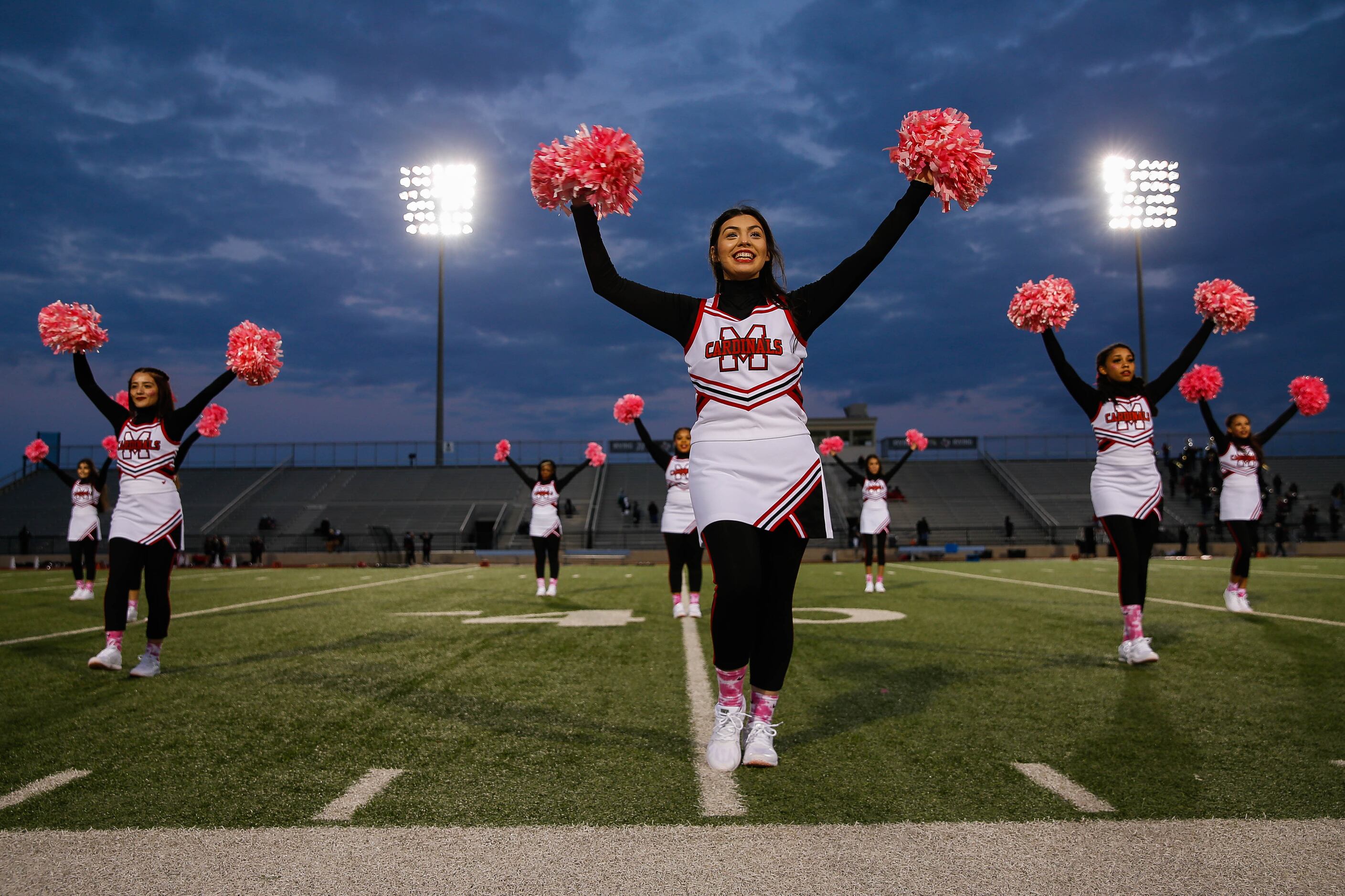 Irving MacArthur High School cheerleaders cheer before a football game against Lake...