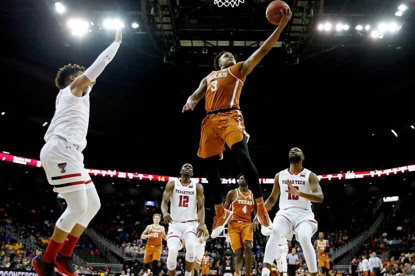 KANSAS CITY, MO - MARCH 08:  Jacob Young #3 of the Texas Longhorns drives toward the basket...