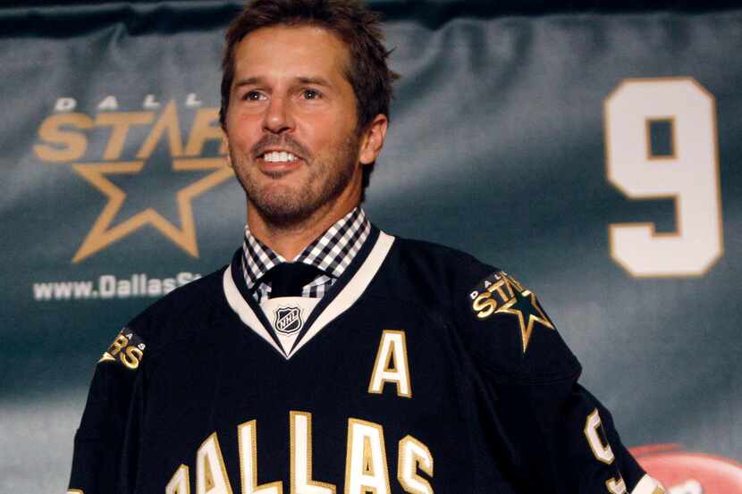 FILE - In this Sept. 23, 2011, file photo, NHL hockey player Mike Modano wears a Dallas...