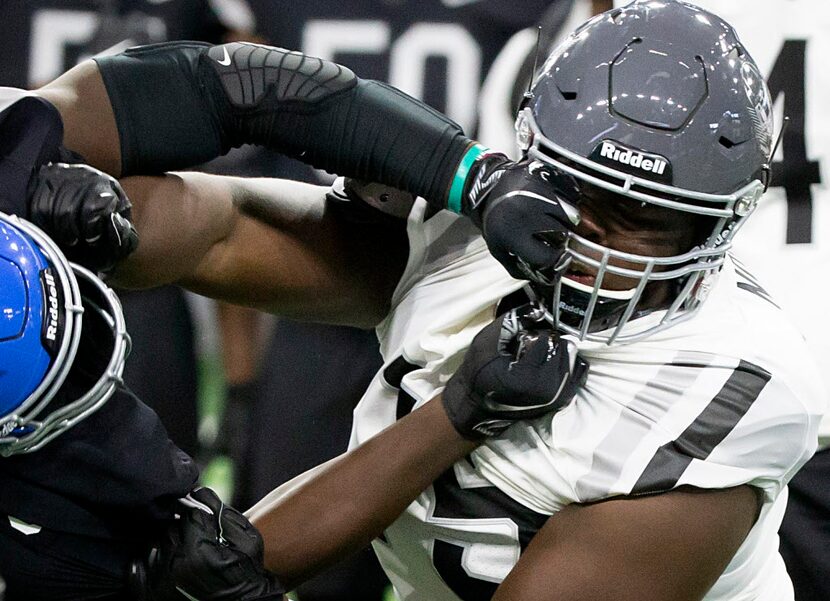 Offensive lineman EJ Ndoma-Ogar (75) works against defensive lineman Marcus Stripling (5)...