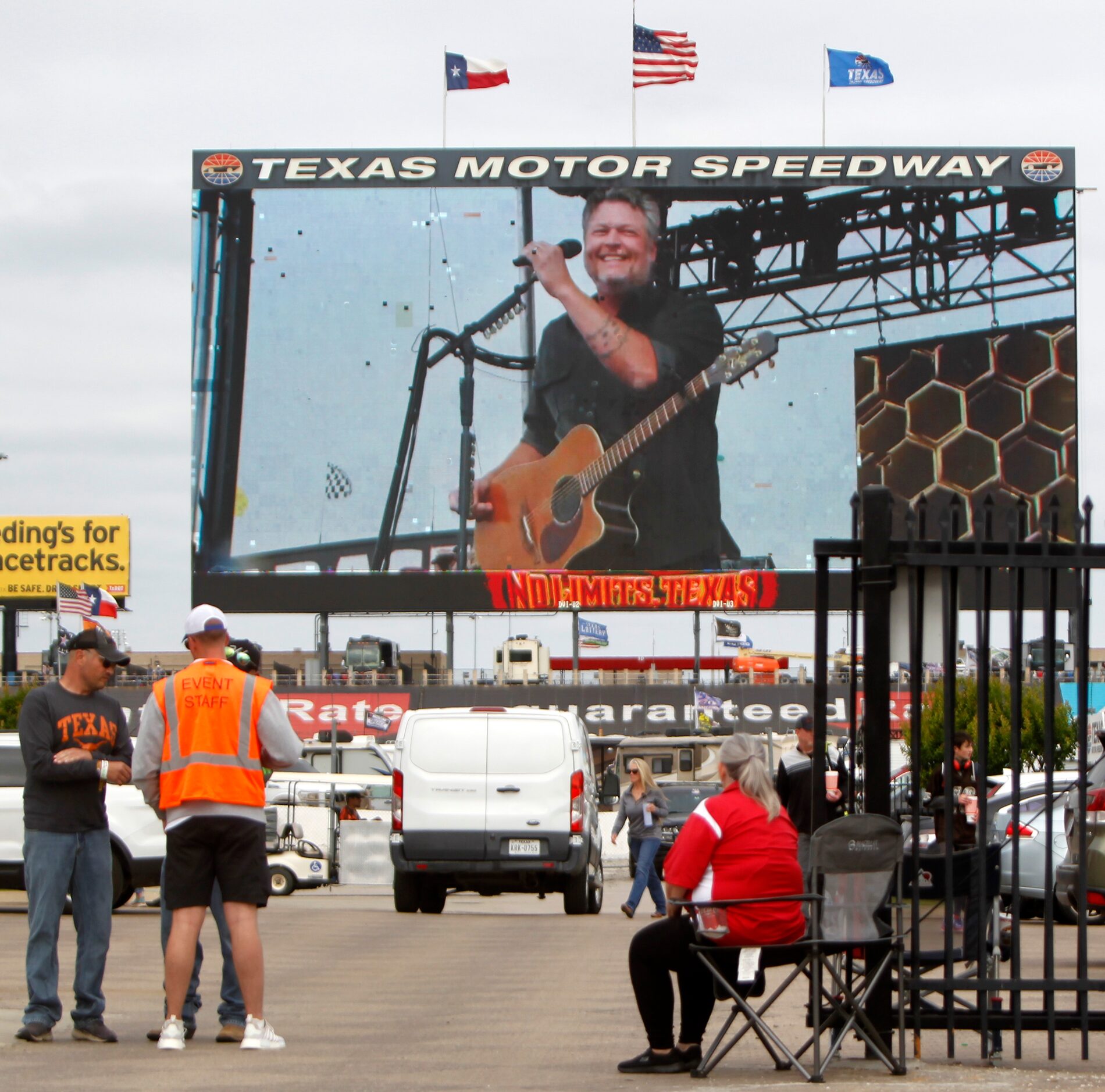 A member of the track security team pauses to take in part of Blake Shelton's concert. The...