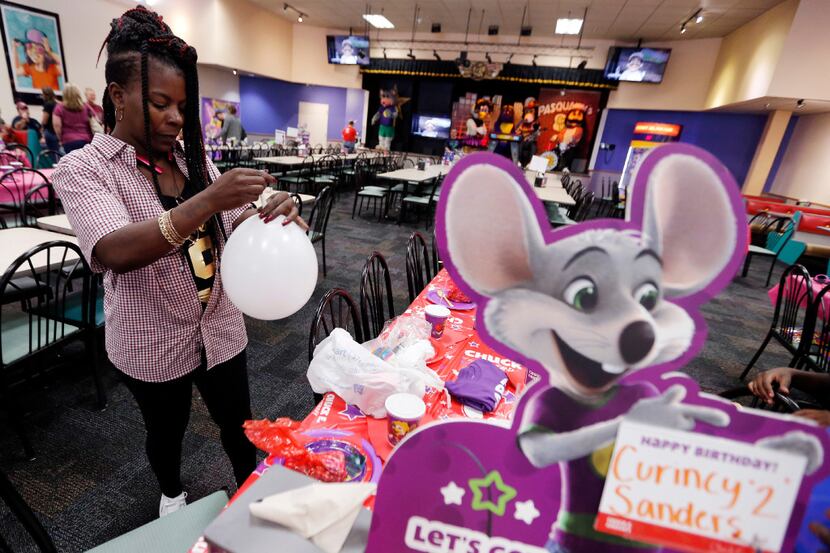 Iris Thomas blows up balloons for her grandson's second birthday party at a Chuck E Cheese...