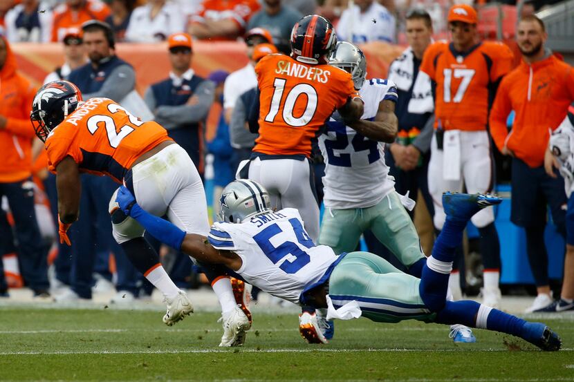 Dallas Cowboys outside linebacker Jaylon Smith (54) reaches for Denver Broncos running back...