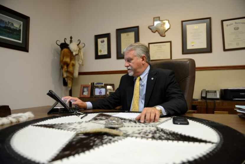 Rockwall's Mayor pro tem Jim Pruitt works at his desk in his law office in downtown...