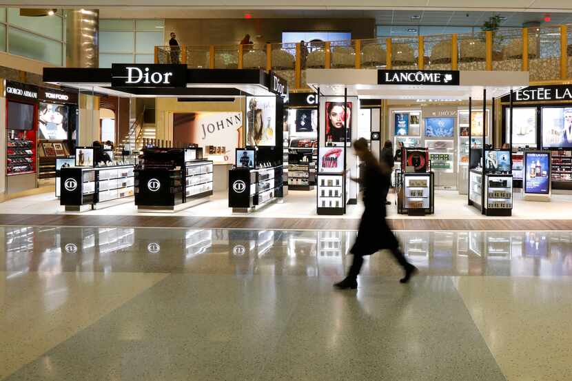 A passenger walks in front of the largest duty-free store in the Americas in Terminal D at...