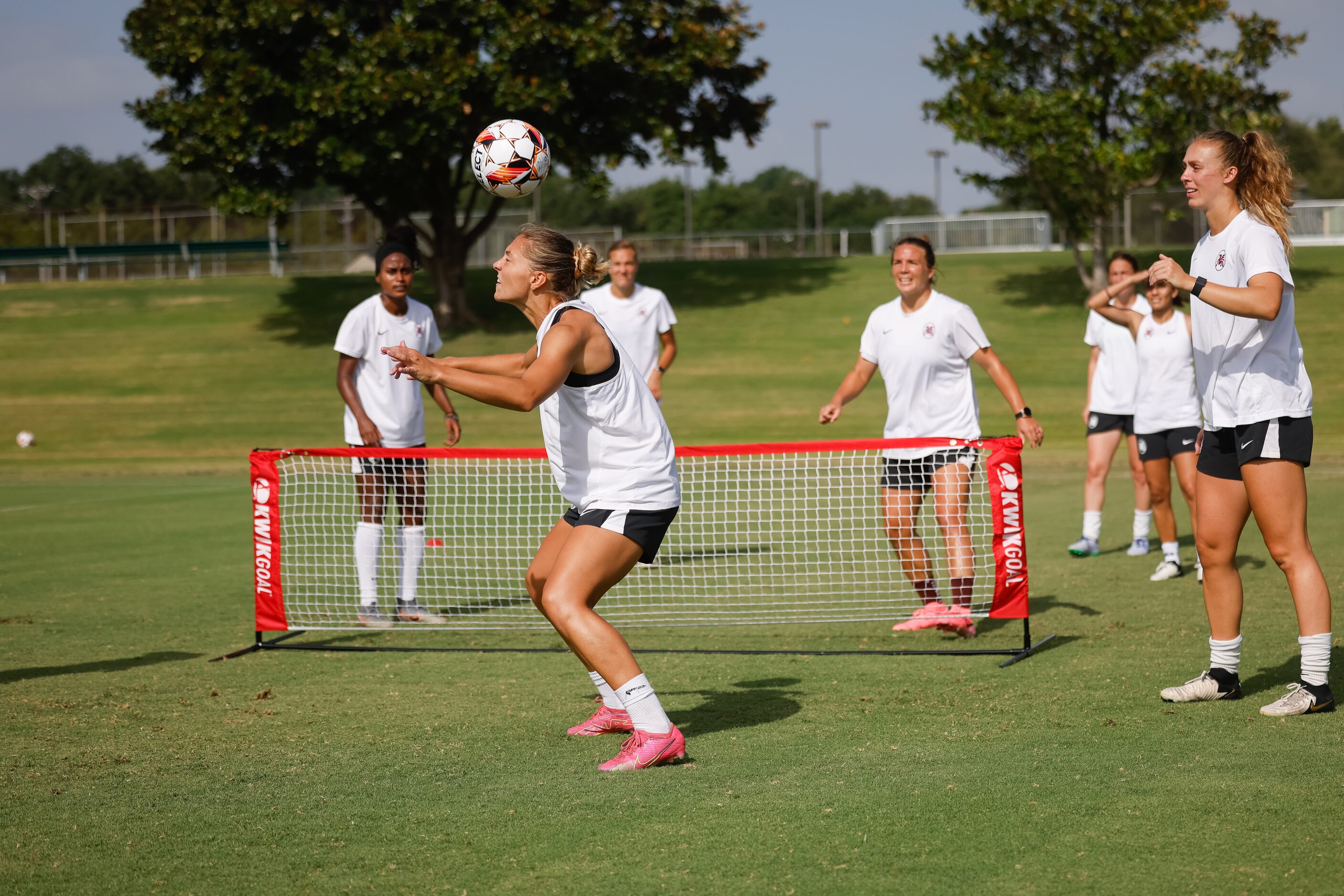 From left, Dallas Trinity FC player Hannah Davison headbutts the ball during the brand new...