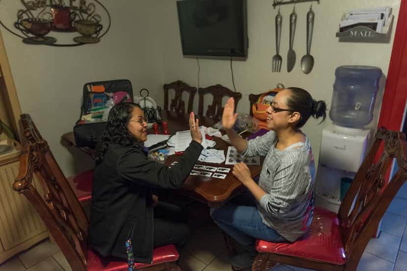 Evelyn Vasquez-Argueta (left), a home instructor with Irving ISD,  congratulates Maria...