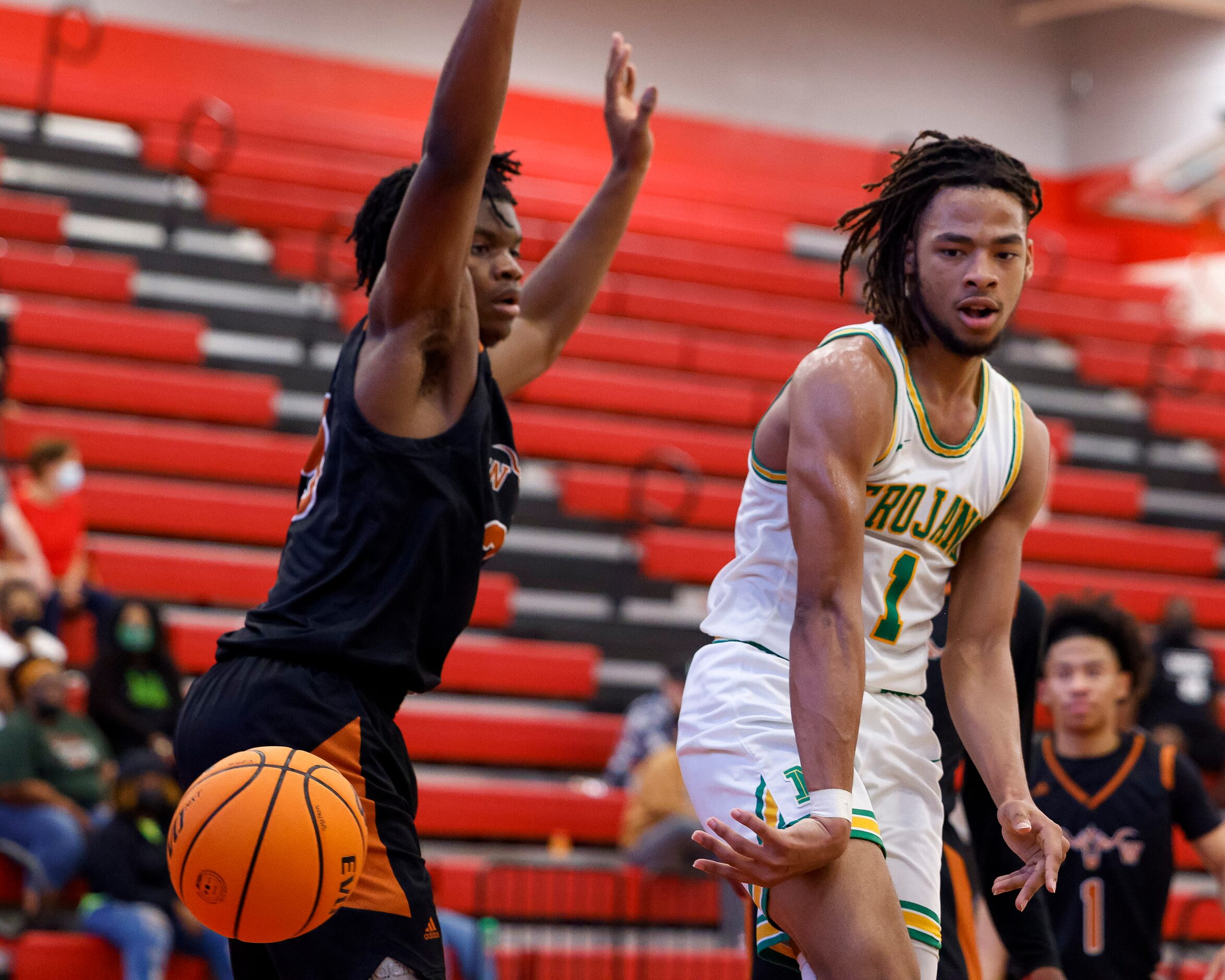 Madison guard Pierre Hunter II (1) attempts a no-look pass around W.T. White forward PJ...