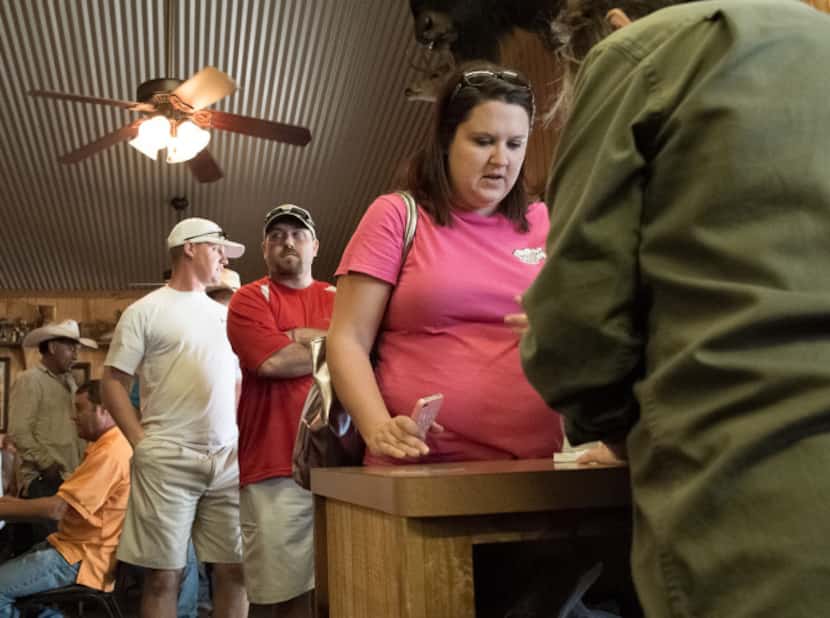 A long line of Friday lunch customers wait to order at Kirby's Barbeque in Mexia.