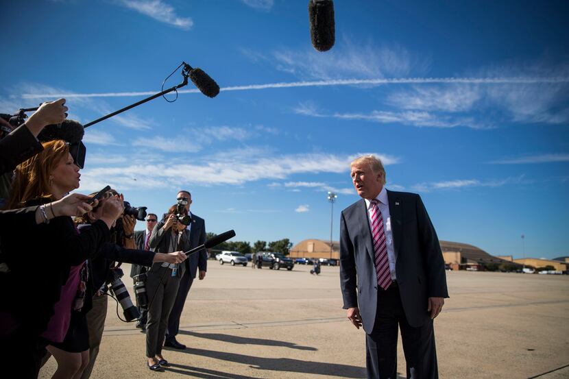 President Donald Trump walks past reporters as he boarded Air Force One in Morristown, N.J.,...
