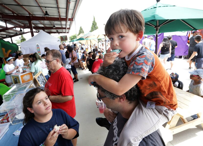 Ten-year-old Zoey Wooten, left, and 4-year-old Rocky Wooten enjoy a macaron with Wayne...