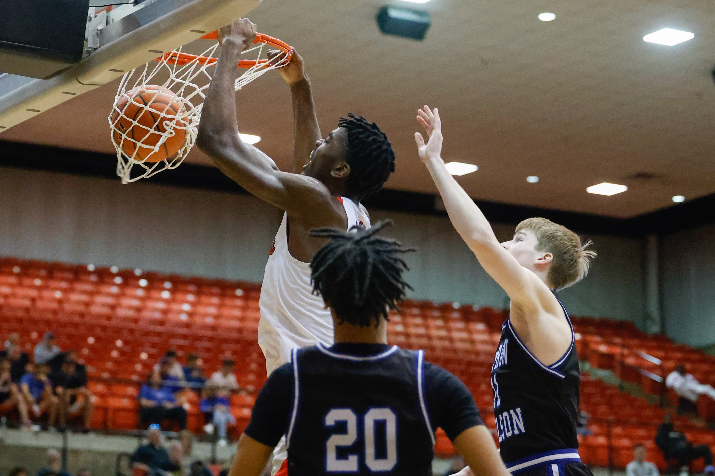 Lake Highlands High School' Samson Aletan dunks the ball against Byron Nelson High School...