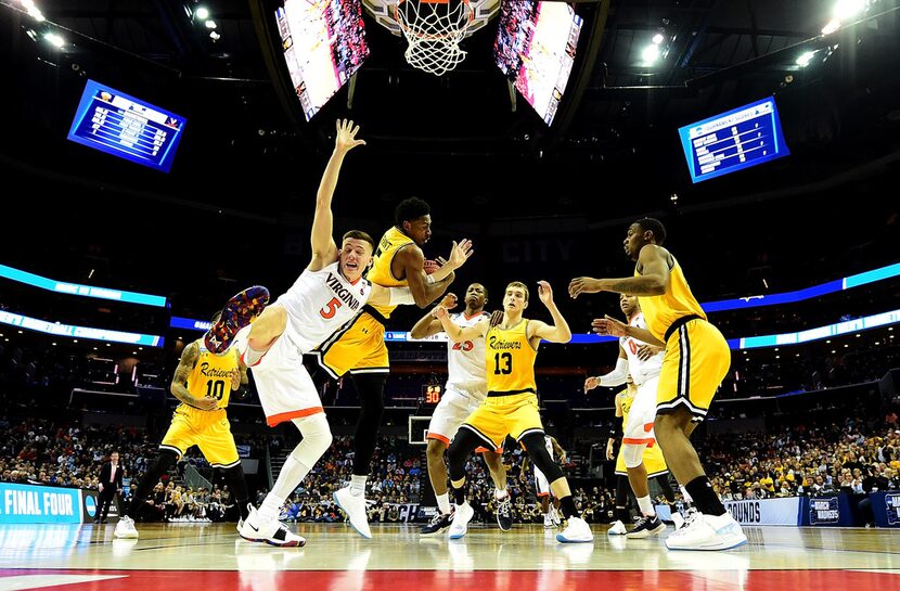 Jourdan Grant (5) of the UMBC Retrievers competes for the ball against Kyle Guy (5) of the...