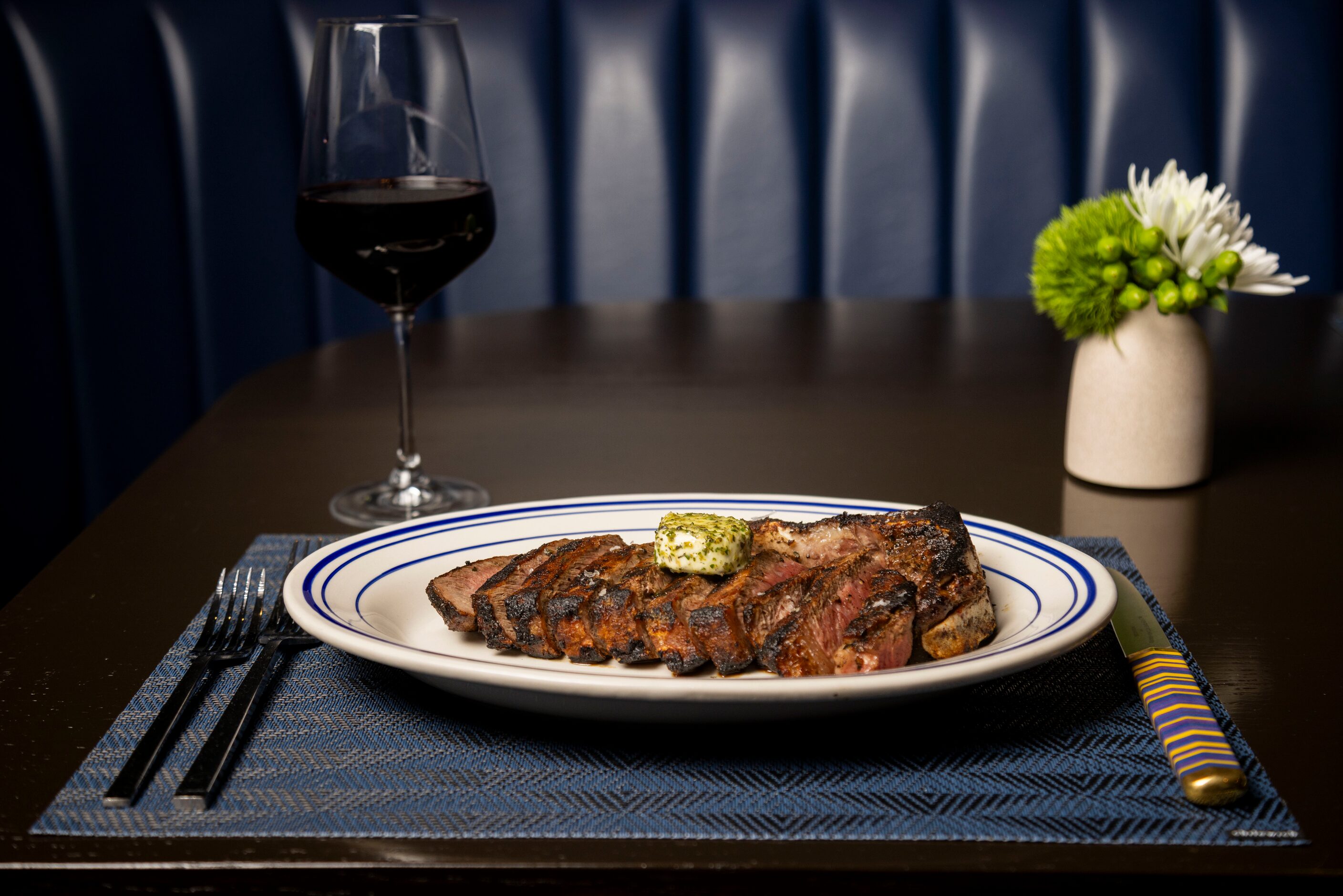 Bone-in New York Strip with herb butter is on the menu at Wicked Butcher in Dallas.