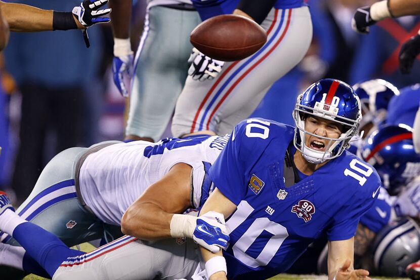 To avoid the sack by Dallas Cowboys defensive tackle Tyrone Crawford (98),New York Giants...