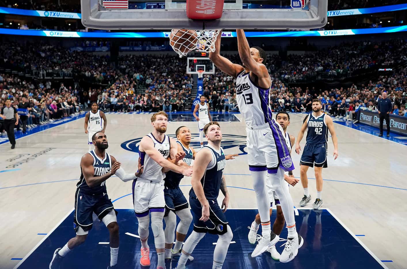 Sacramento Kings forward Keegan Murray (13) dunks the ball past Dallas Mavericks guard Luka...