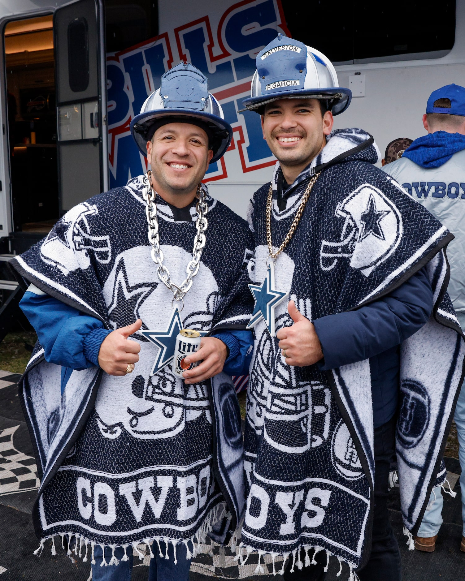 Galveston firefighters John Garcia (left) and Rob Garcia pose for a photo before an NFL game...