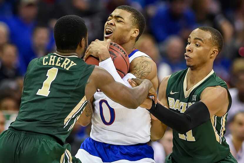 Kansas' Frank Mason III (0) fights the defense of Baylor's Kenny Chery (1) and Lester...