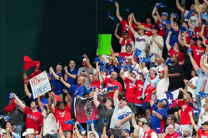 Texas Rangers fans cheer their team during the first inning against the Boston Red Sox at...